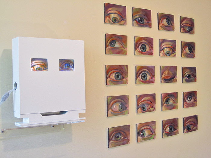 Installation view of "Googlie" shows the paintings next to the video.