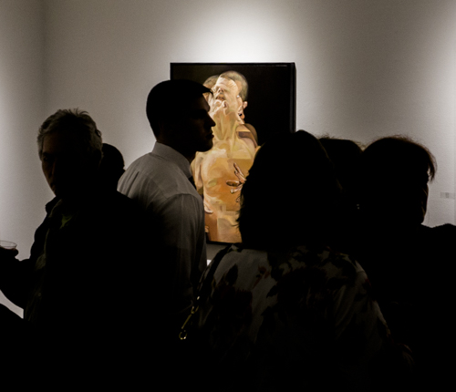 Scott Hutchison's painting Displaced can be seen in the background of a crowd of people.